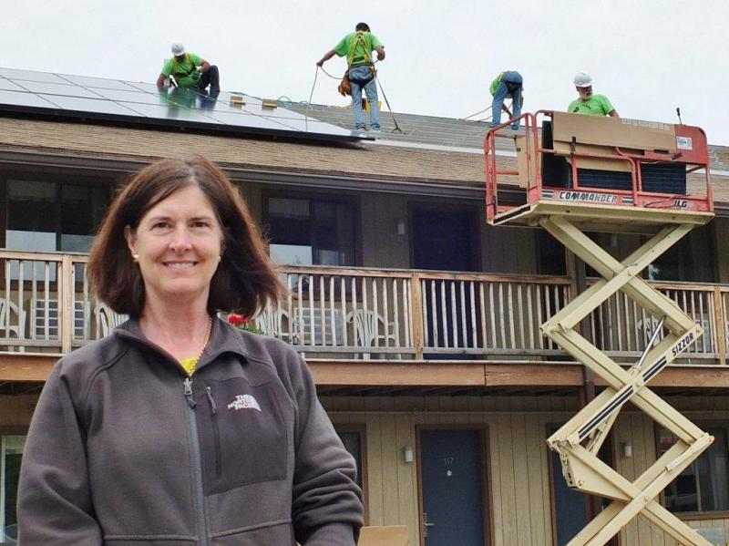 Ann (Robinson) Goggin of Goggin Energy oversees the solar panel installation at Boothbay Harbor's Flagship Inn on June 13. Goggin's solar panels convert direct current from the sun into alternating current right at the solar panel. The panels will offset the Flagship's electricity bill starting July 1.